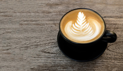 Top view of hot coffee latte art on wood table background