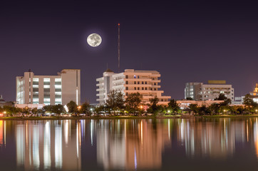 Fototapeta na wymiar Building a city on the moon reflecting pool at night.