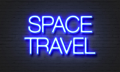 Space travel neon sign on brick wall background.