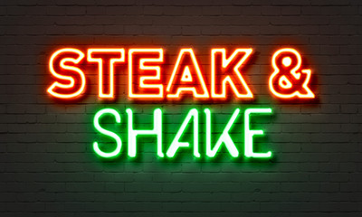 Steak & shake neon sign on brick wall background.