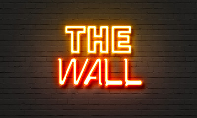 The wall neon sign on brick wall background.