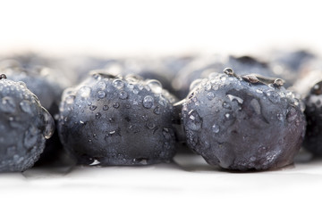 Closeup of  fresh blueberry and waterdrops on the white background