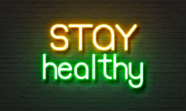 Stay Healthy Neon Sign On Brick Wall Background.