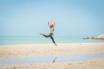 girl jump on  the beach, happy on vacation time