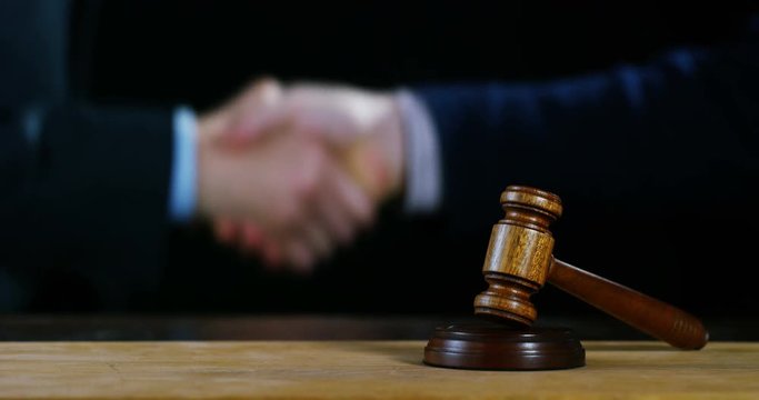 hand shake, auction scene of lawyers or notaries with gavel judge for the insurance compensation or criminal cases. concept of law and lawyer, judiciary and legislature applied to the democratic law.
