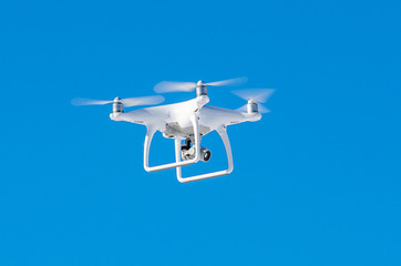 Quadrocopter drone with mounted digital camera for video and photo productions