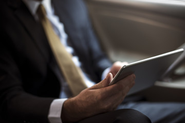 Businessman Using Tablet Working Car Inside
