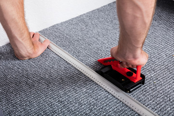 Craftsman's Hands Laying Carpet