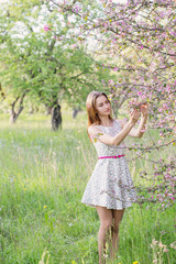 girl with flowers on spring garden