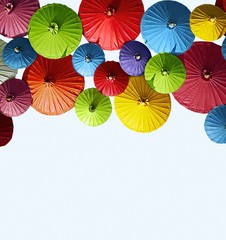 Colorful paper umbrellas on a white background.
