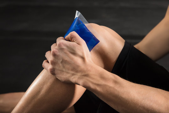 Person Applying Ice Bag On Knee