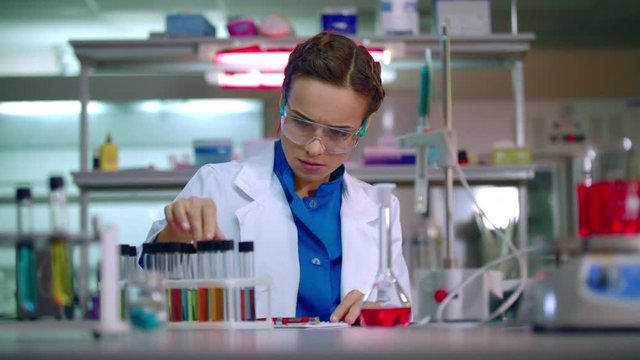 Medical researcher in medical research lab. Clinical research. Medical lab technician working in chemical laboratory. Lab doctor writing test result. Medical scientist working at the lab