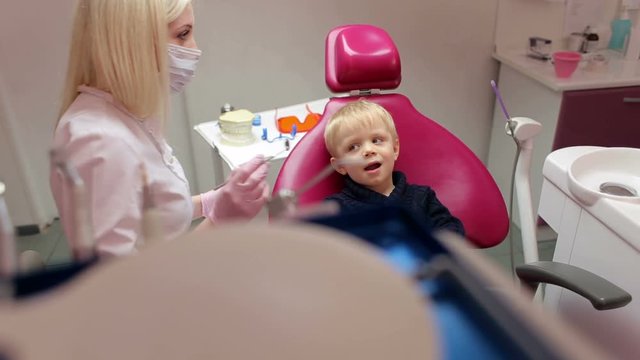 Little boy sitting in the dentists office.