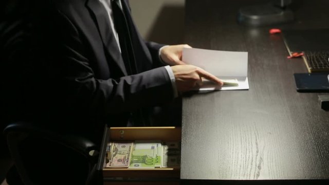 corruption, bribery and fraud concept - close up of businessman taking money