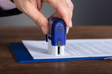 Person's Hand Stamping Document