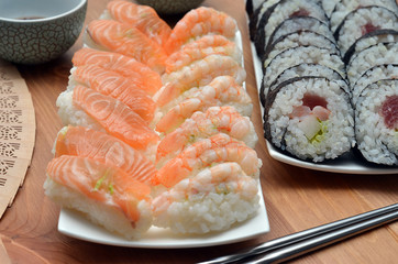 maki sushi rolls and nigiri sushi with salmon and shrimp japan food on the table detail
