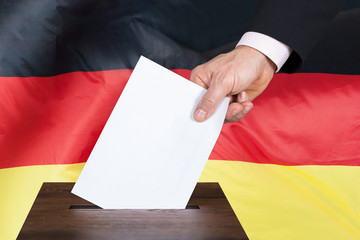 Person Putting Vote In A Ballot Box
