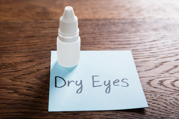 Dry Eyes Concept On Wooden Desk