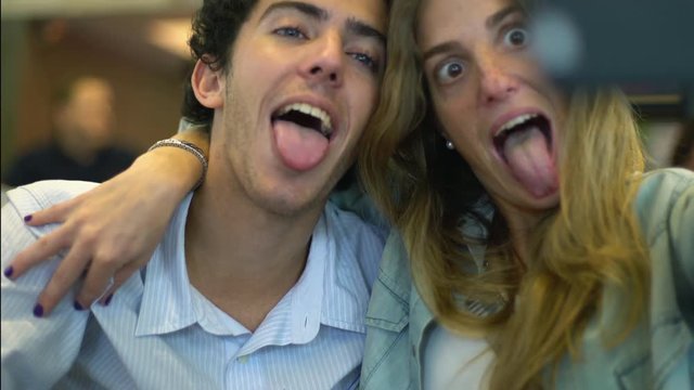 Young couple making faces for fun selfie