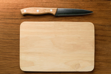 the knife on the kitchen Board and wood background