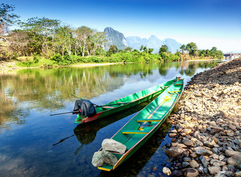 Lao Traditional boats on the shore of a mountain river