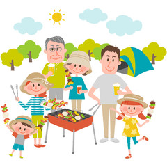 family enjoying barbecue outdoors