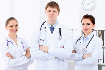 Happy female doctor with medical staff at the hospital. Successful team at health care concept