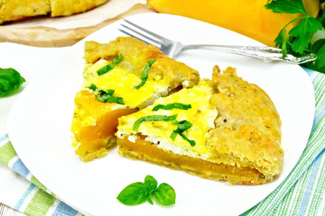 Pie of pumpkin and cheese in plate on light board