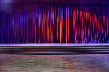 Red curtains and wooden stage.