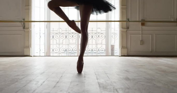 Ballerina performing pirouettes in studio, slow motion