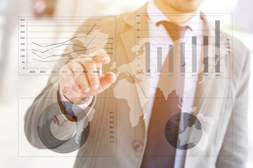 Asia businessman hand pushing business graph on touch screen interface