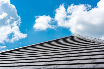 roof tiles with blue sky background - obrazy, fototapety, plakaty