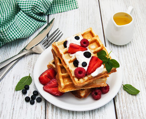 waffles with strawberries,  blueberry and sauce