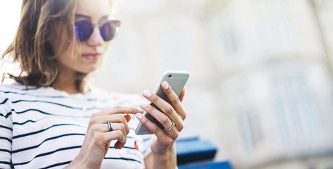 Hipster texting message on smartphone or technology, mockup of blank screen. Girl using cellphone...