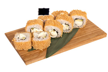 Sushi rolls on wooden Board with leaves of leeks and black sign for logo and name