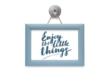 Enjoy the little things. Modern calligraphy. Motivational quote. Blue photo frame - isolated