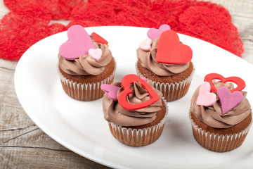 Cupcakes with cream decorated with heart