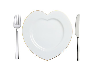 white plate in shape of heart, spoon and fork isolated on white
