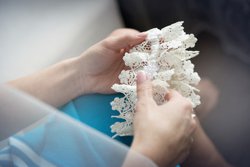 wedding garter in his hands