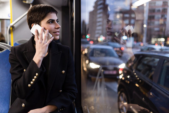 Woman talking phone in bus