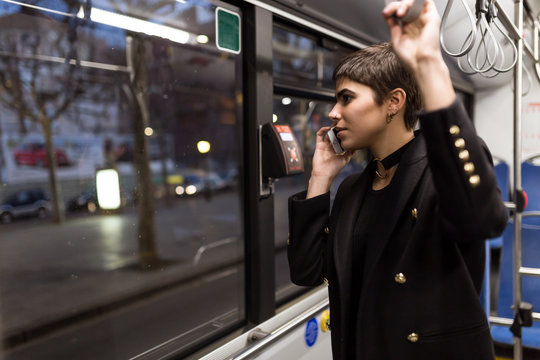 Woman using phone on the bus