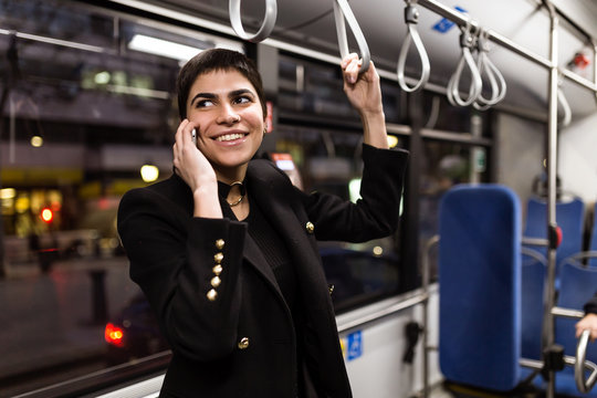 Smiling female talking in the bus
