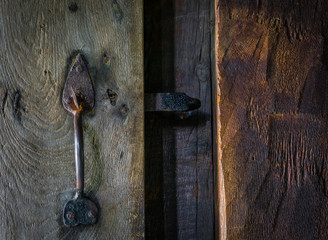 The old wooden door with latch and lock