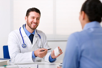 Doctor smiling looking at patient