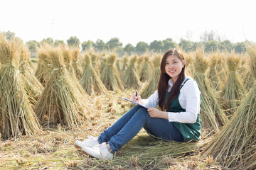 young asian woman in golden cereal field