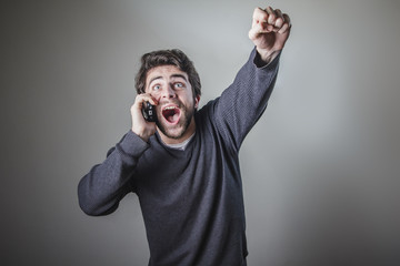 Good news, young man receiving great news over hiss cell phone