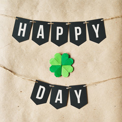 HAPPY ST. PATRICK'S DAY black banner lettering on eco craft paper background. Irish national holiday square postcard, greeting card, invitation, poster.