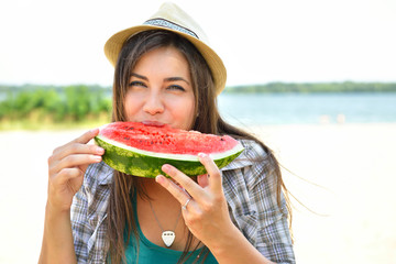 Happy young woman eating watermelon on the beach. Youth lifestyle. Happiness, joy, holiday, beach,...