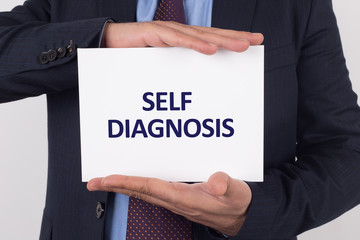 Man showing paper with SELF DIAGNOSIS text