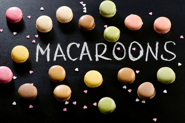 Colorful macaroons on a black background.